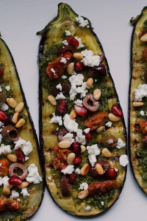 Gegrilde aubergine met feta, olijven, granaatappelpitjes en limoenpesto